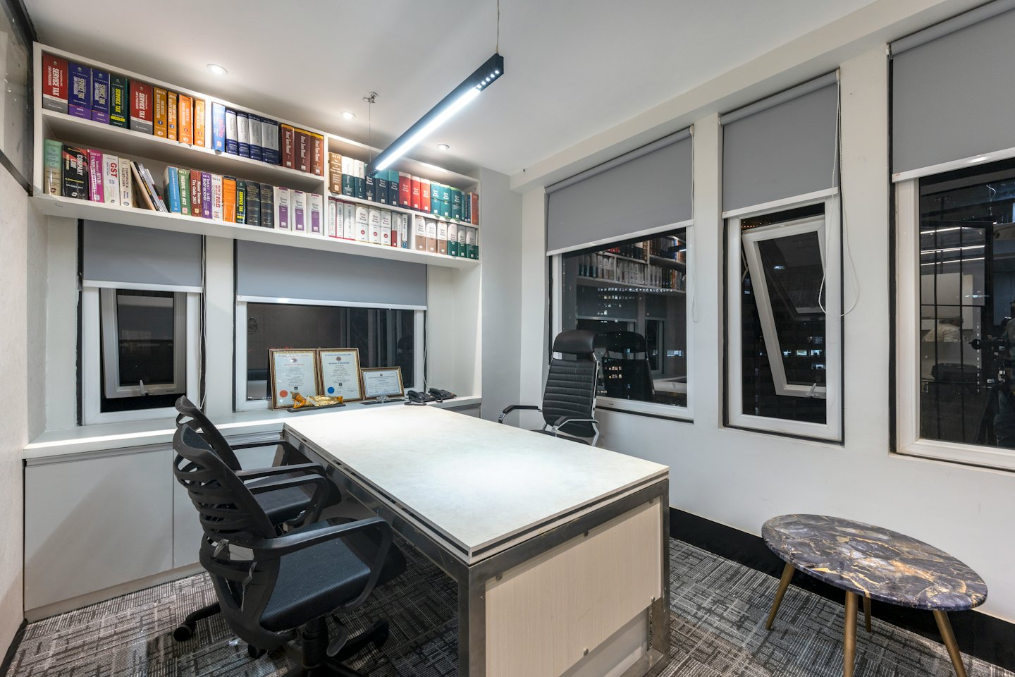 Professional office with a large desk and law library bookshelves.